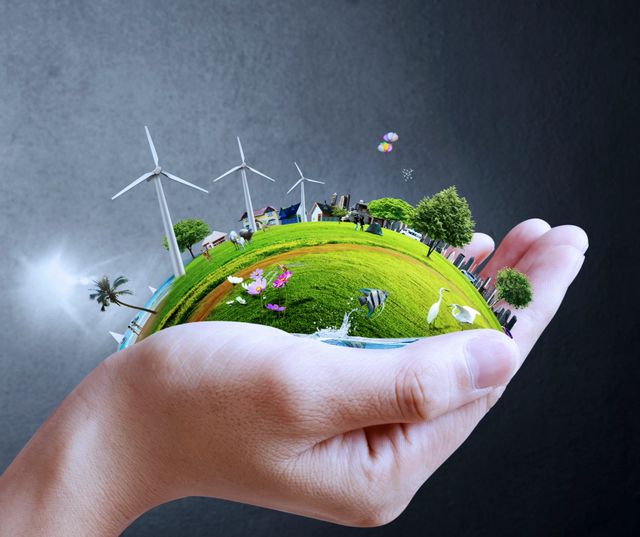 A hand holding an earth with wind turbines in the background.